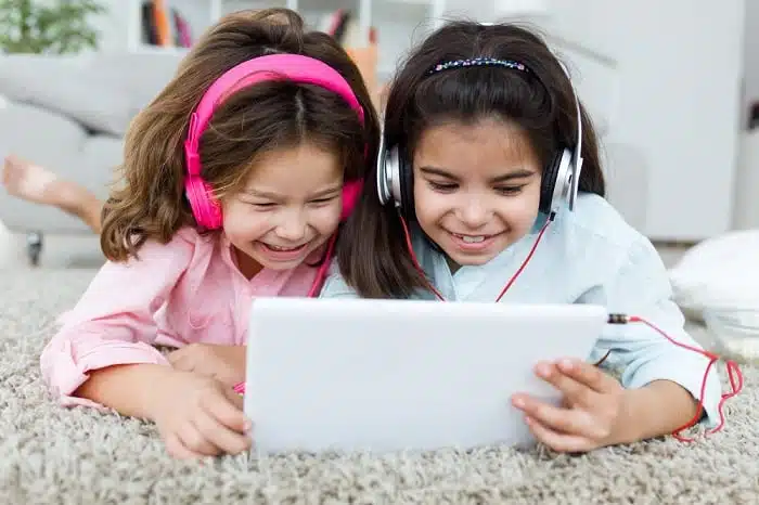 Child engrossed in excessive screen time on a tablet